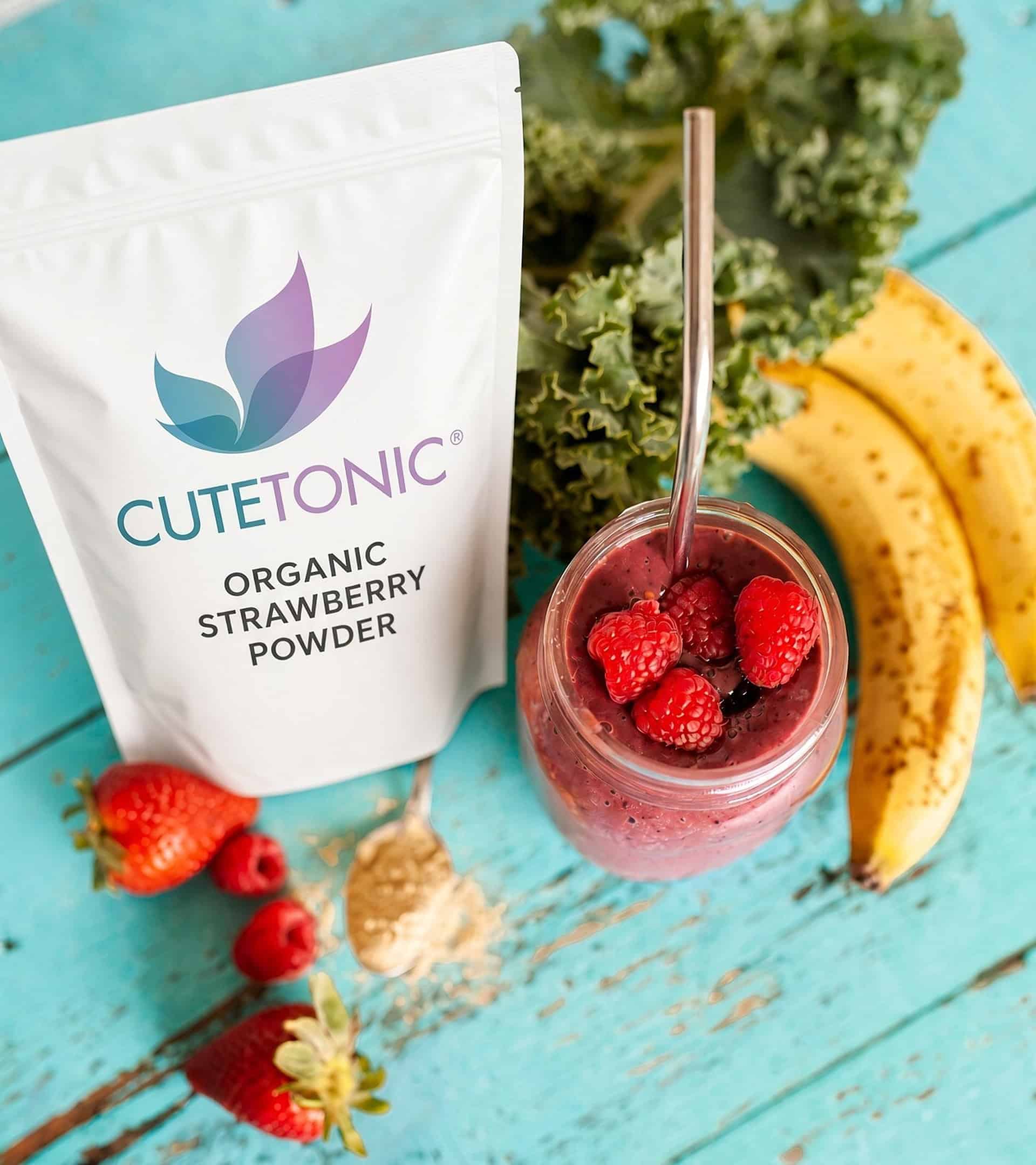 Cutetonic fruit powder pouch beside a raspberry smoothie